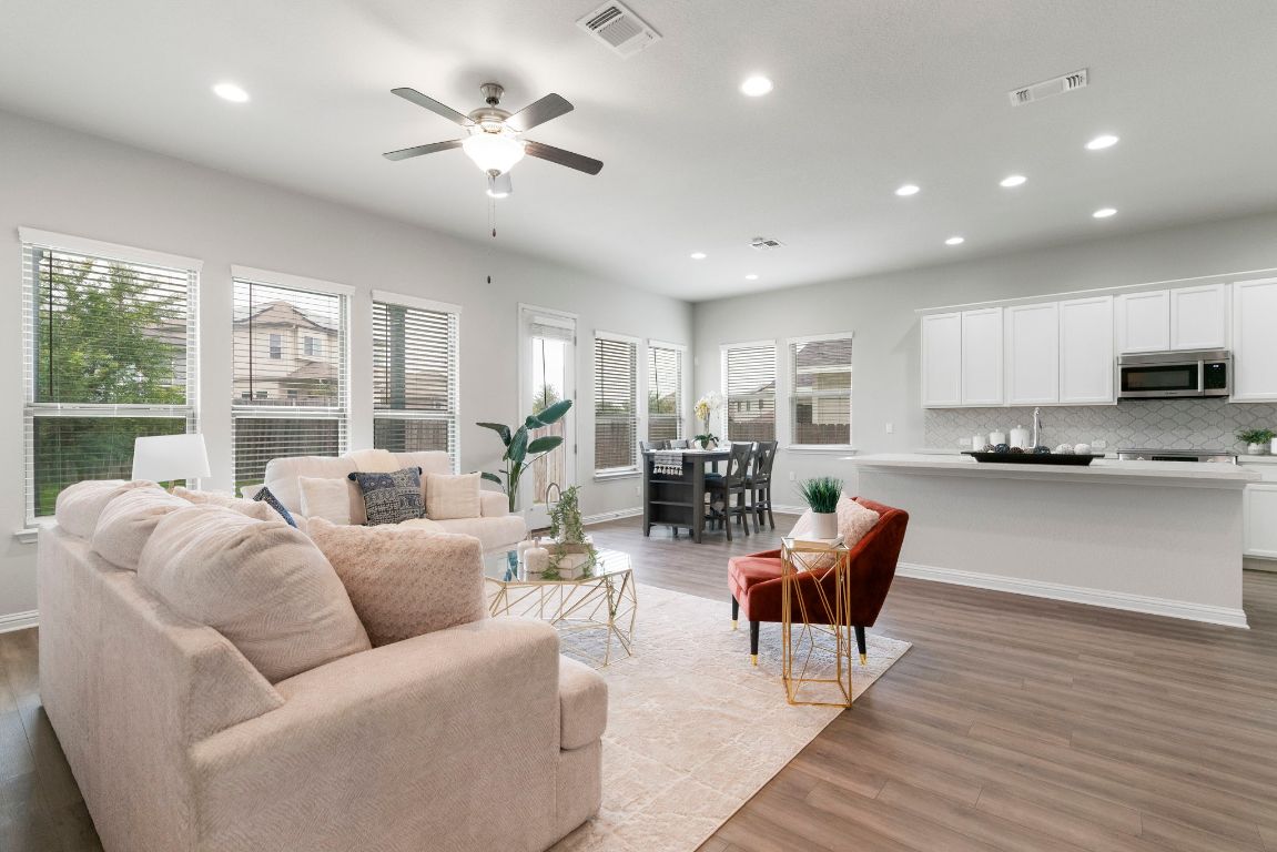 a living room with furniture and large windows