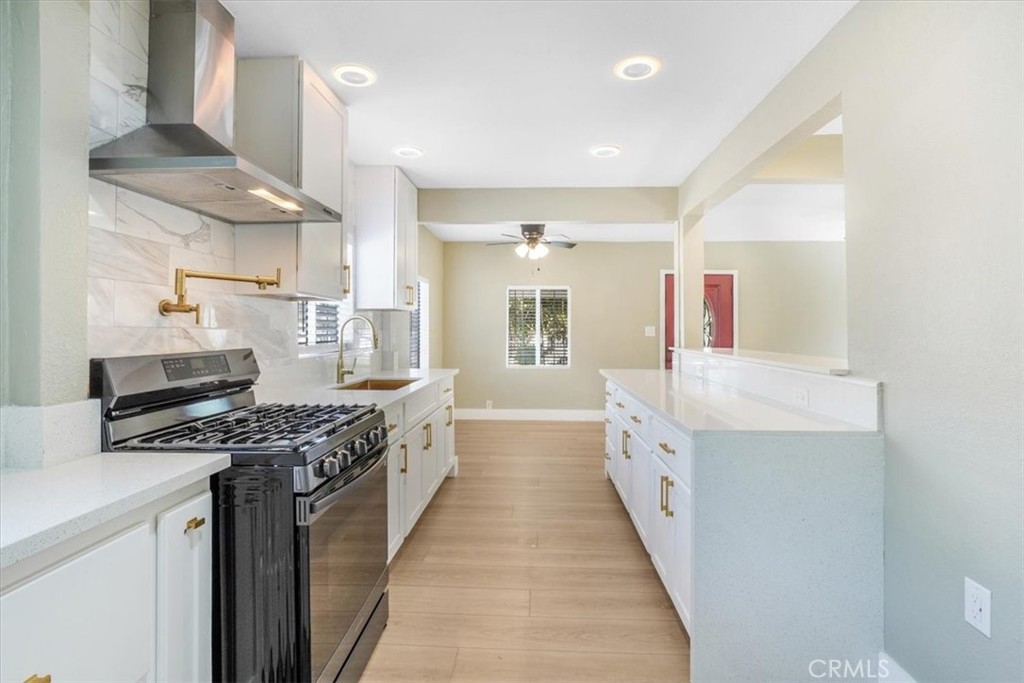 13737 Mercer Street Pacoima, CA 91331 - Photo 11 of 35 a kitchen with stainless steel appliances a sink and a stove