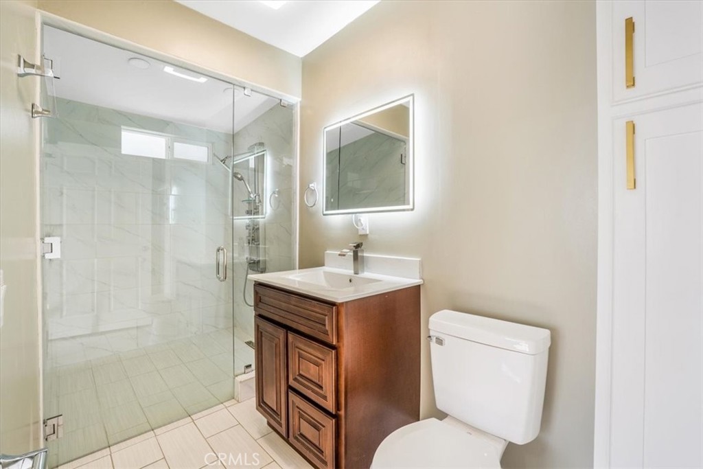 13737 Mercer Street Pacoima, CA 91331 - Photo 17 of 35 a bathroom with a toilet sink vanity and shower