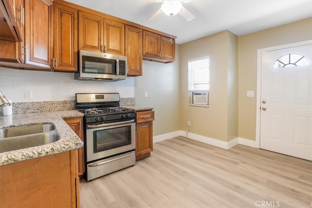 13737 Mercer Street Pacoima, CA 91331 - Photo 23 of 35 a kitchen with granite countertop a sink and steel appliances