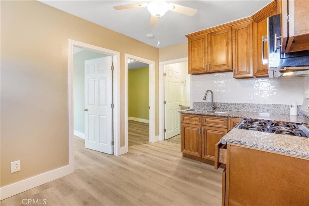 13737 Mercer Street Pacoima, CA 91331 - Photo 24 of 35 a kitchen with stainless steel appliances granite countertop a sink stove and refrigerator