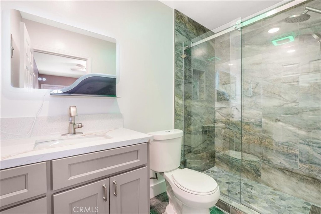 13737 Mercer Street Pacoima, CA 91331 - Photo 26 of 35 a bathroom with a sink toilet vanity and shower