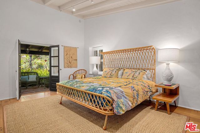 a view of a porch with chairs and backyard