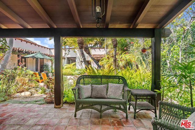 a bedroom with a bed a mirror and a large window