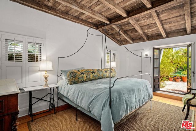 a bedroom with bed and a window