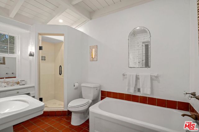 a view of a patio with a table and chairs under an umbrella