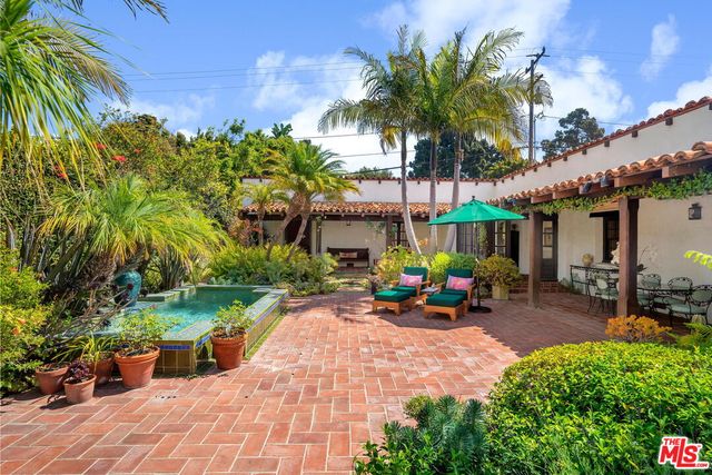 a view of a chairs and table in the patio