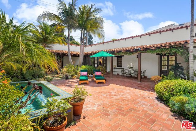 a view of a garden with sitting area