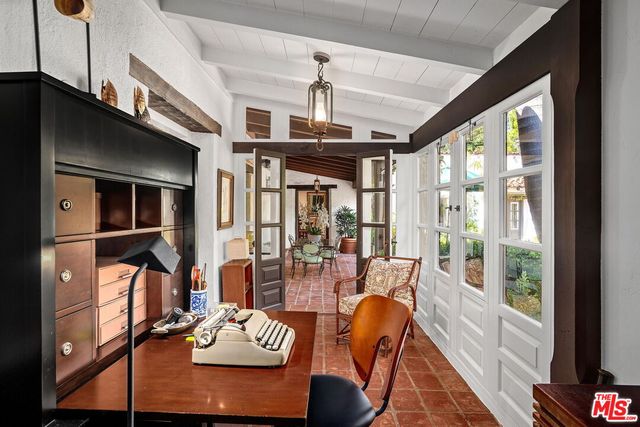 a living room with furniture ceiling fan and a window