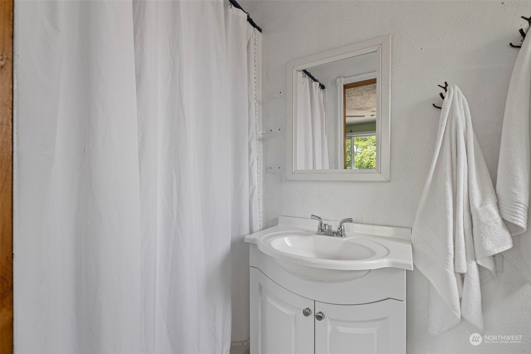 2042 East 18th Street Bremerton, WA 98310 - Photo 16 of 33 a bathroom with a sink a mirror and a window
