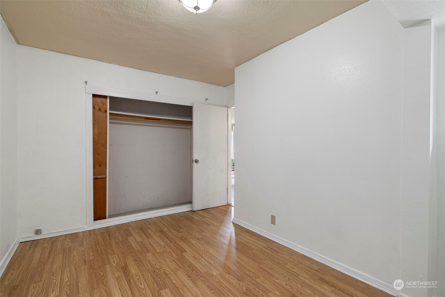 2042 East 18th Street Bremerton, WA 98310 - Photo 22 of 33 a view of an empty room with wooden floor and closet