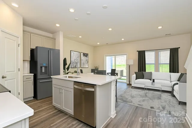 a kitchen with a sink appliances and cabinets