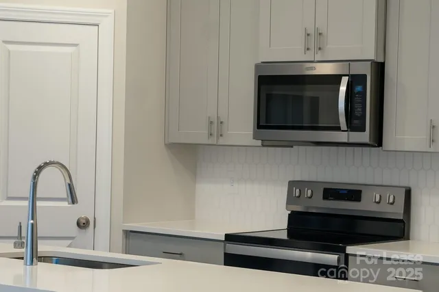 a kitchen with a stove and a microwave