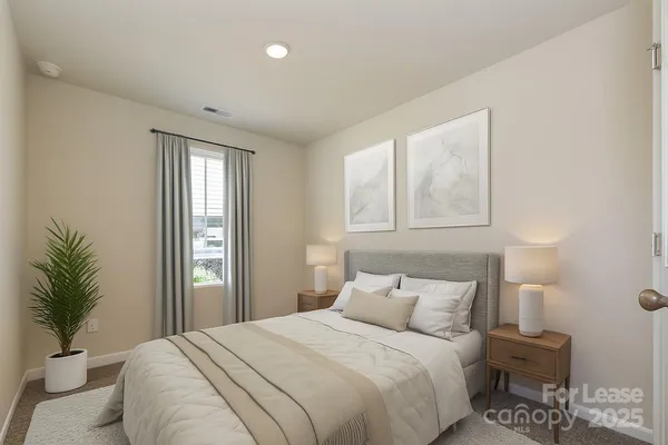 a bedroom with a large bed and a window