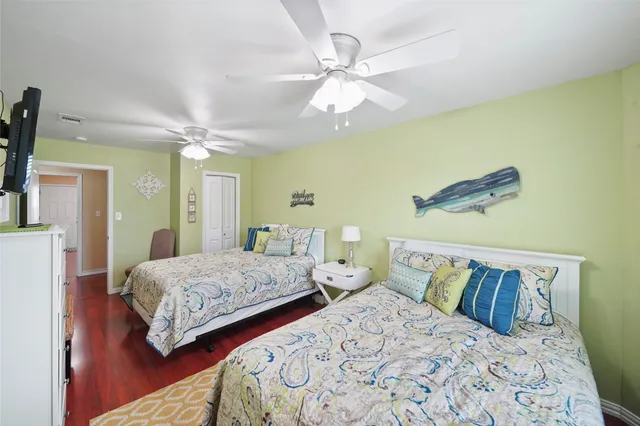 a bedroom with two beds and painting on the wall