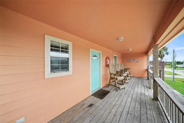 a view of a living room and a wooden deck