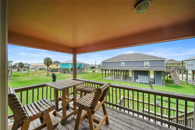 a view of a chair and tables in the balcony