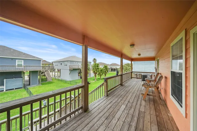 a view of a balcony with wooden floor