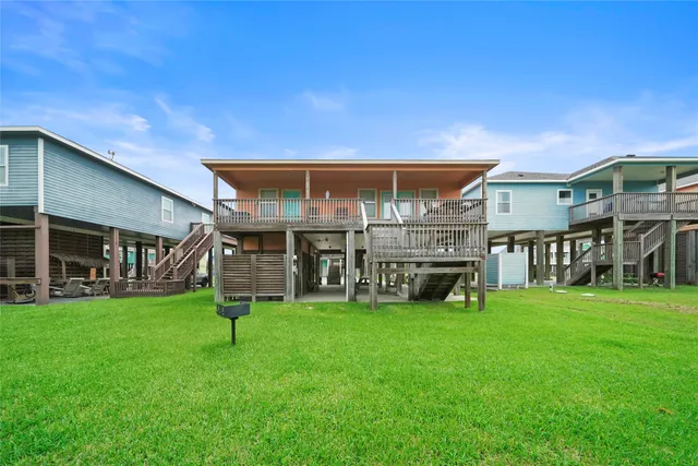 a view of a house with a yard and sitting area