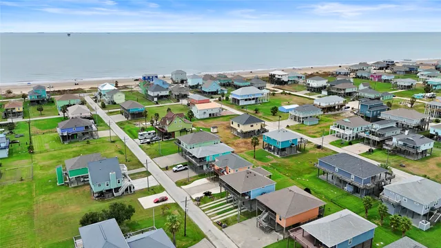an aerial view of multiple houses with yard