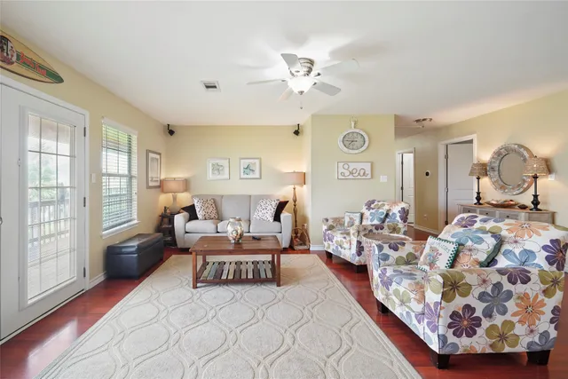 a living room with furniture and wooden floor