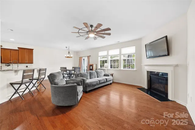 a living room with furniture and a ceiling fan