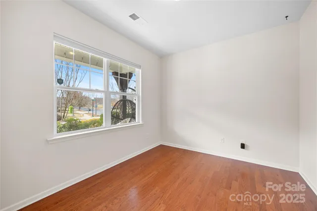 a kitchen with furniture a refrigerator and a view of living room