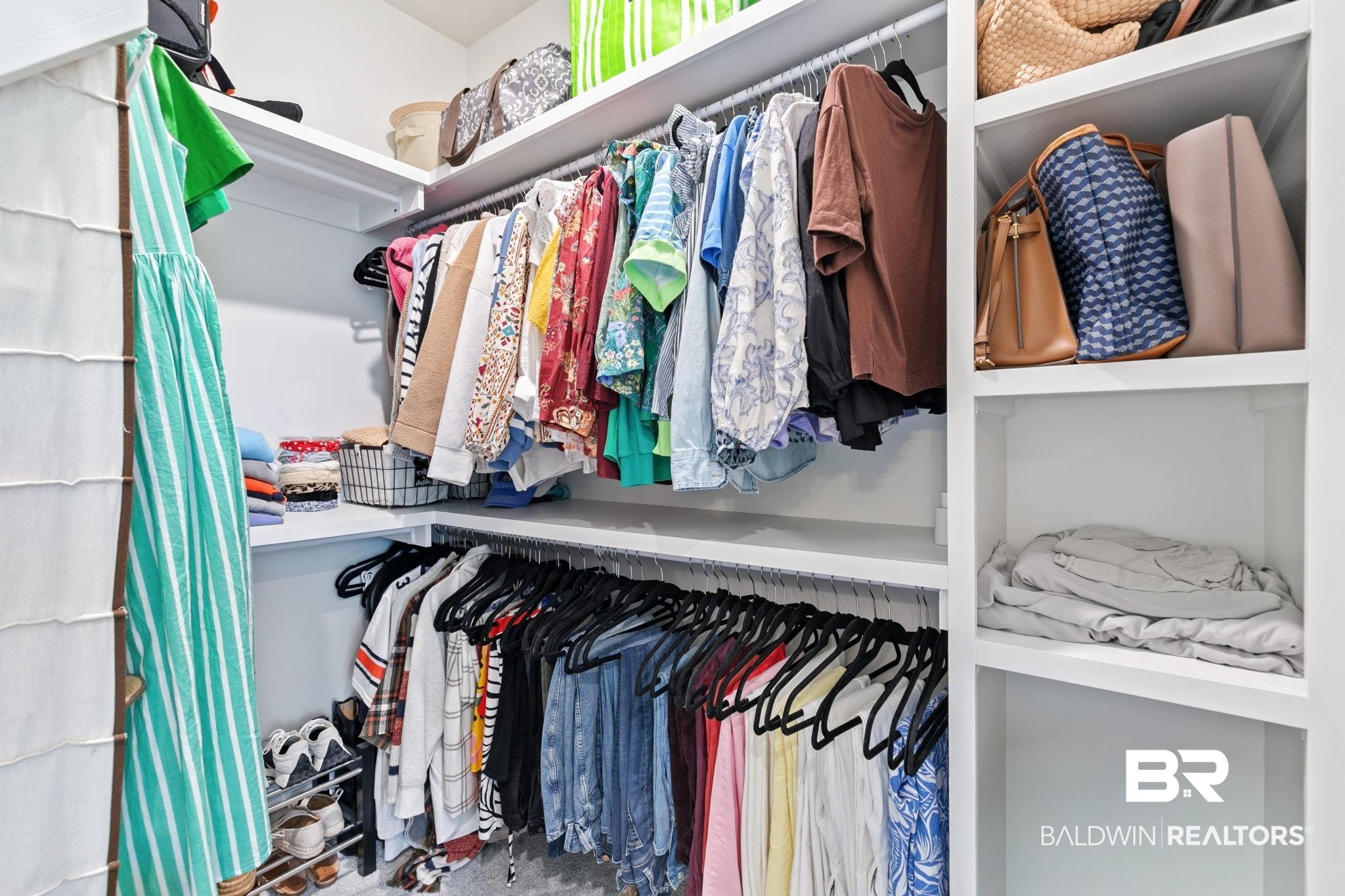 13233 Ibis Boulevard Daphne, AL 36527 - Photo 36 of 100 Built-in closet system featuring multiple hanging rods, corner shelving, and dedicated shoe storage