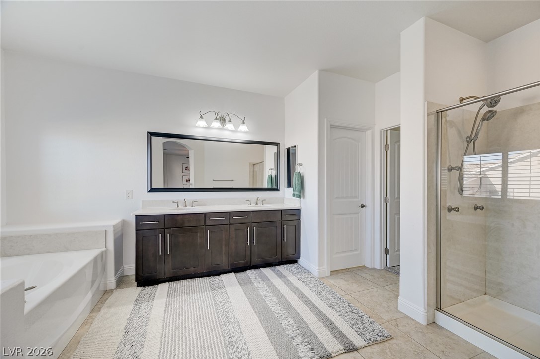 176 Kirkton Street Henderson, NV 89012 - Photo 40 of 80 Spa-inspired bathroom featuring separate soaking tub and walk-in shower