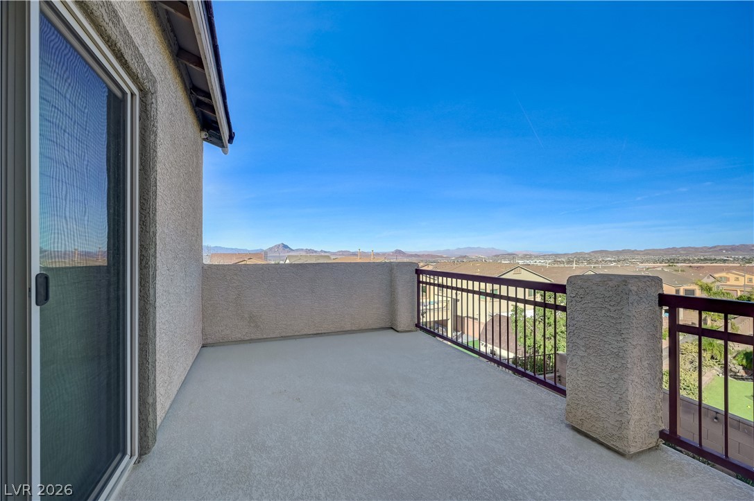 176 Kirkton Street Henderson, NV 89012 - Photo 55 of 80 Elevated lot showcasing stunning city and Strip views ~ Primary bedroom balcony