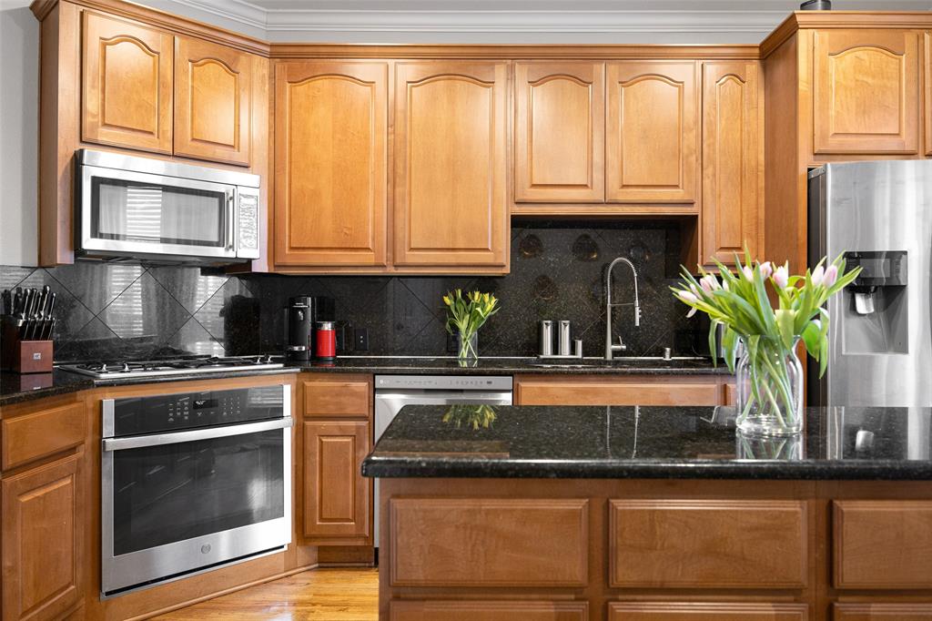 3610 Gillespie Street, Unit 6 Dallas, TX 75219 - Photo 14 of 27 a kitchen with stainless steel appliances granite countertop a stove a sink and a microwave