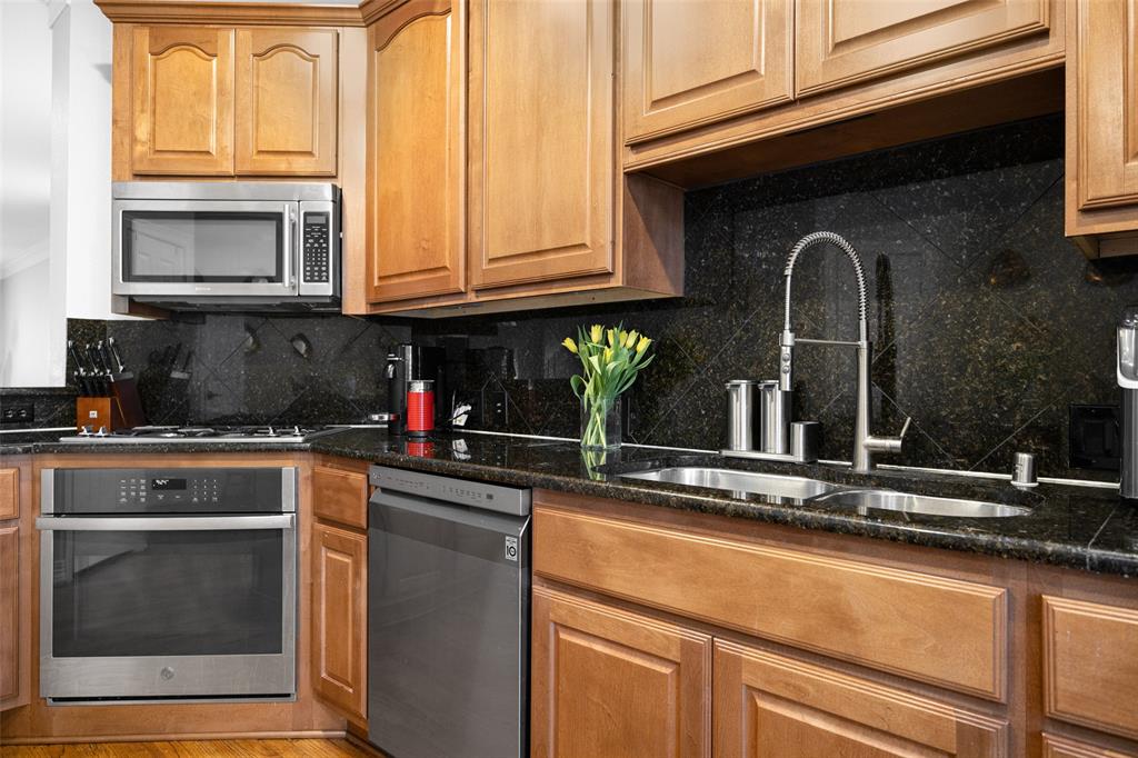 3610 Gillespie Street, Unit 6 Dallas, TX 75219 - Photo 15 of 27 a kitchen with stainless steel appliances granite countertop a sink and cabinets with granite countertops