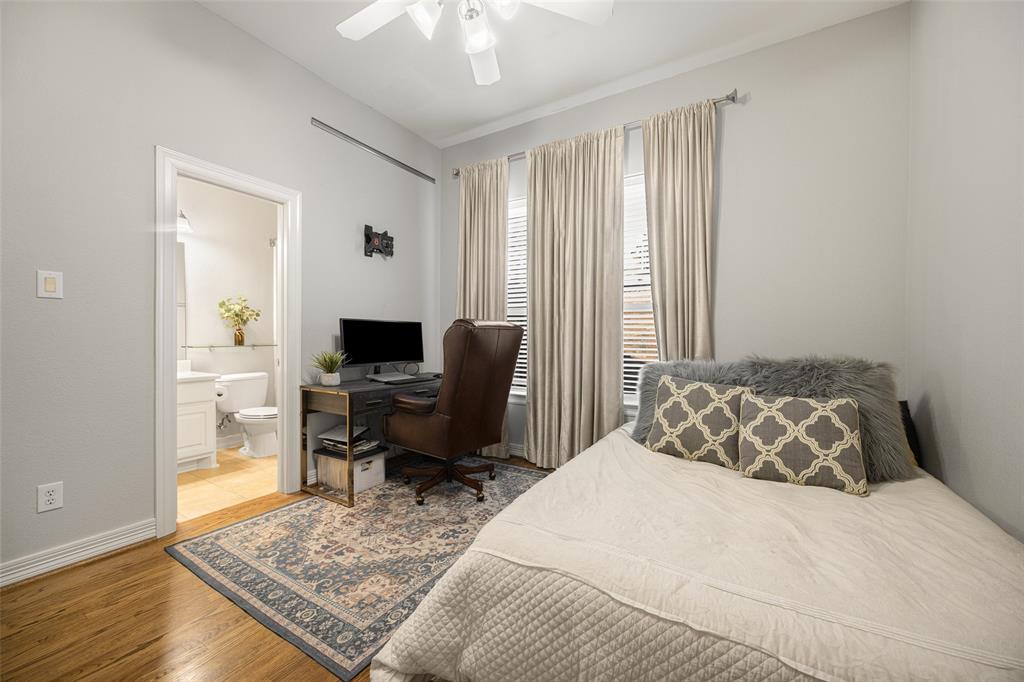 3610 Gillespie Street, Unit 6 Dallas, TX 75219 - Photo 19 of 27 a bedroom with a bed and wooden floor