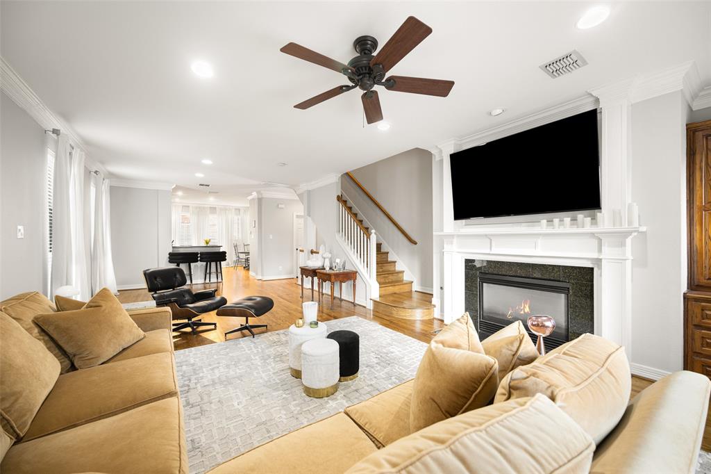 3610 Gillespie Street, Unit 6 Dallas, TX 75219 - Photo 3 of 27 a living room with furniture a fireplace and a flat screen tv