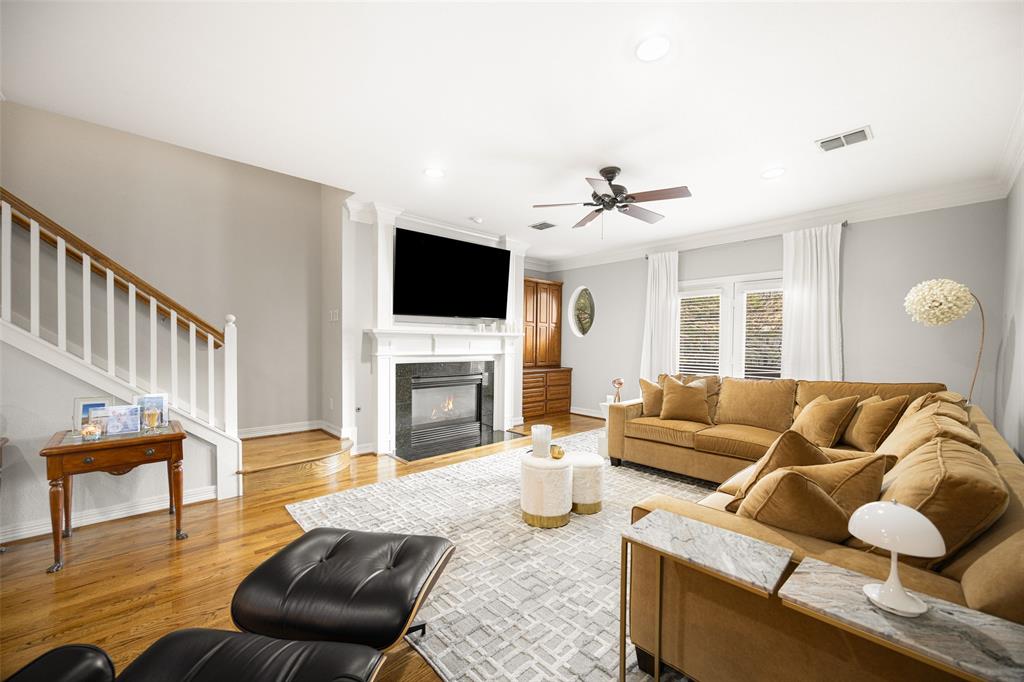 3610 Gillespie Street, Unit 6 Dallas, TX 75219 - Photo 7 of 27 a living room with furniture a fireplace and a flat screen tv
