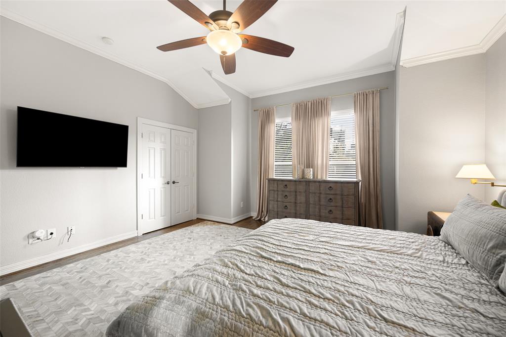 3610 Gillespie Street, Unit 6 Dallas, TX 75219 - Photo 9 of 27 a bedroom with a bed and a flat screen tv