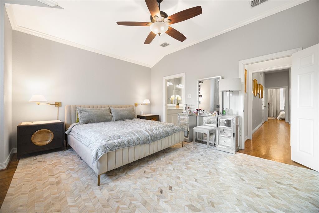 3610 Gillespie Street, Unit 6 Dallas, TX 75219 - Photo 10 of 27 a bedroom with a bed and a chandelier