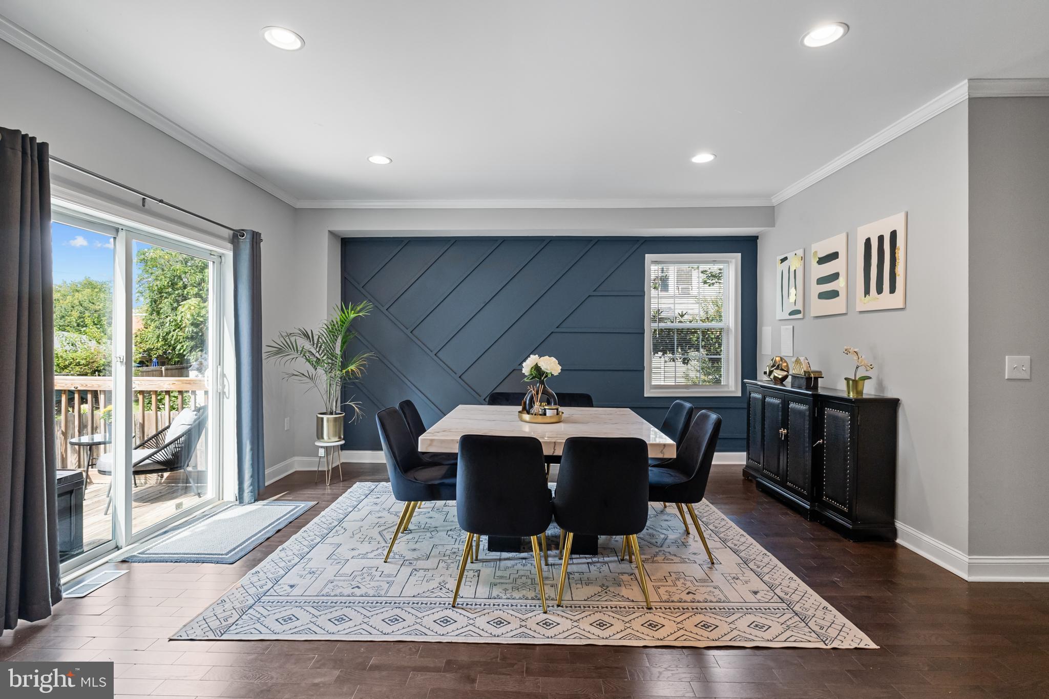 3327 5th Street Southeast Washington, DC 20032 - Photo 17 of 42 a dining room with wooden floor and white walls