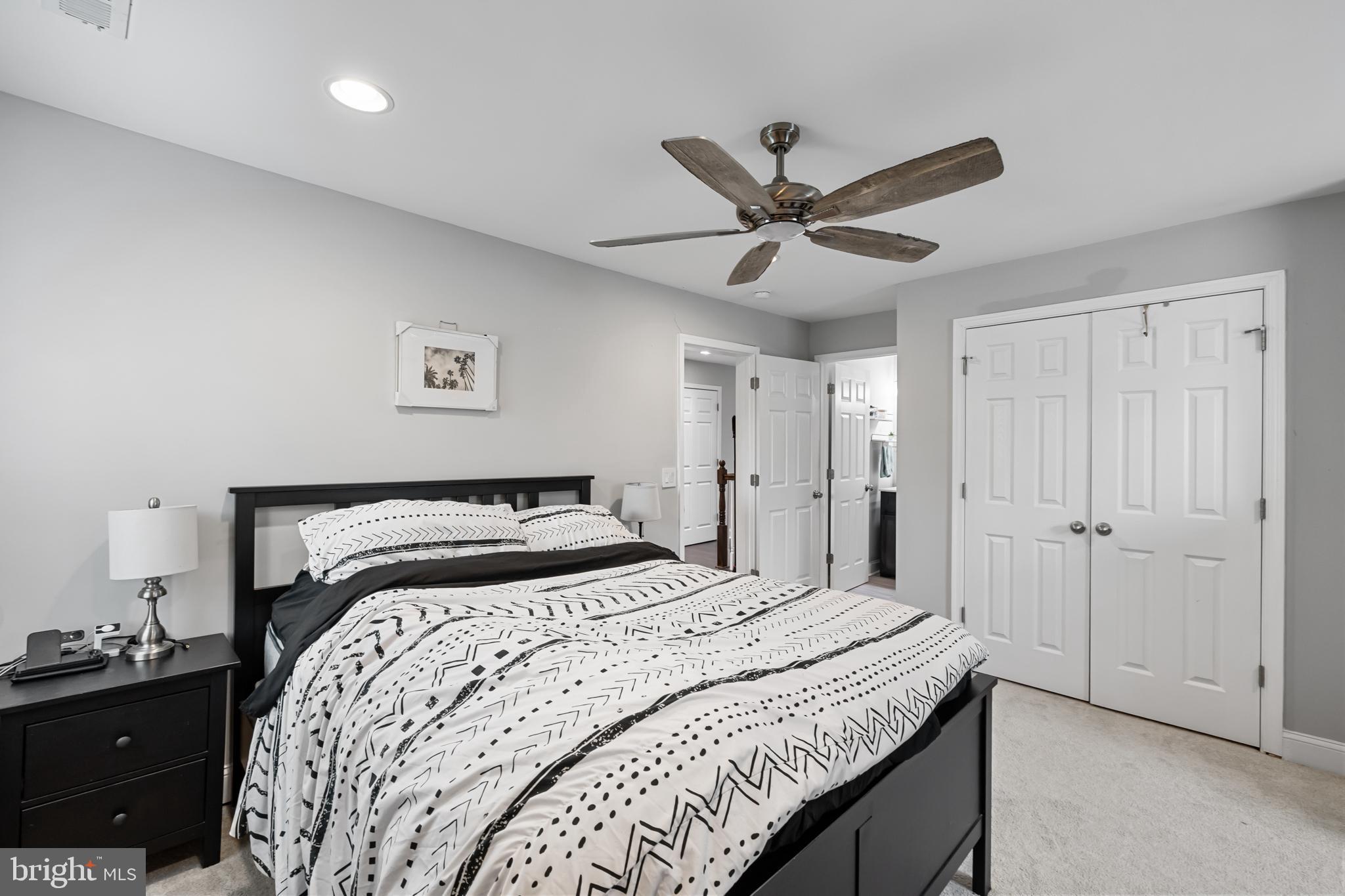 3327 5th Street Southeast Washington, DC 20032 - Photo 27 of 42 a bedroom with a bed and a chandelier