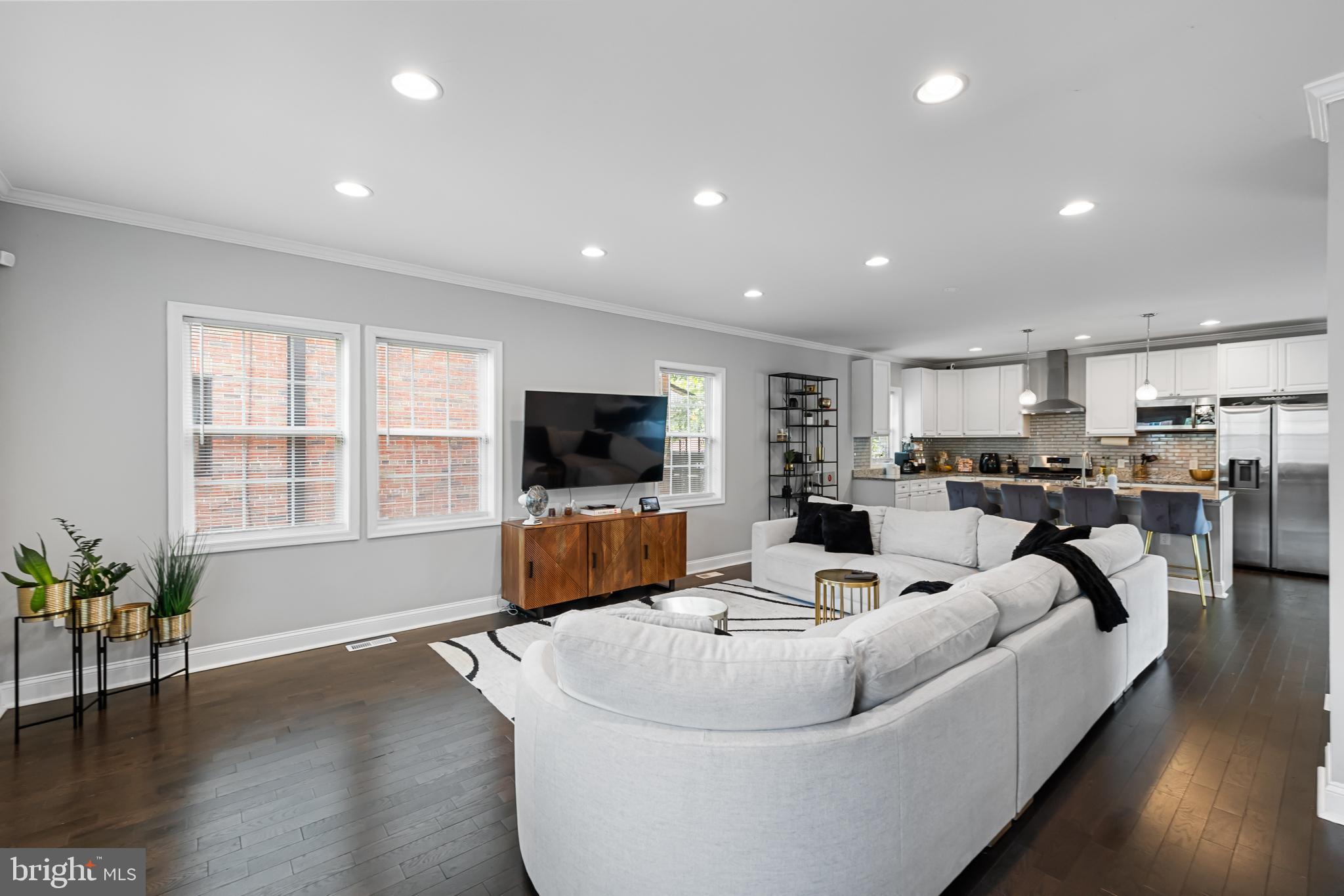 3327 5th Street Southeast Washington, DC 20032 - Photo 5 of 42 a living room with furniture kitchen view and a flat screen tv