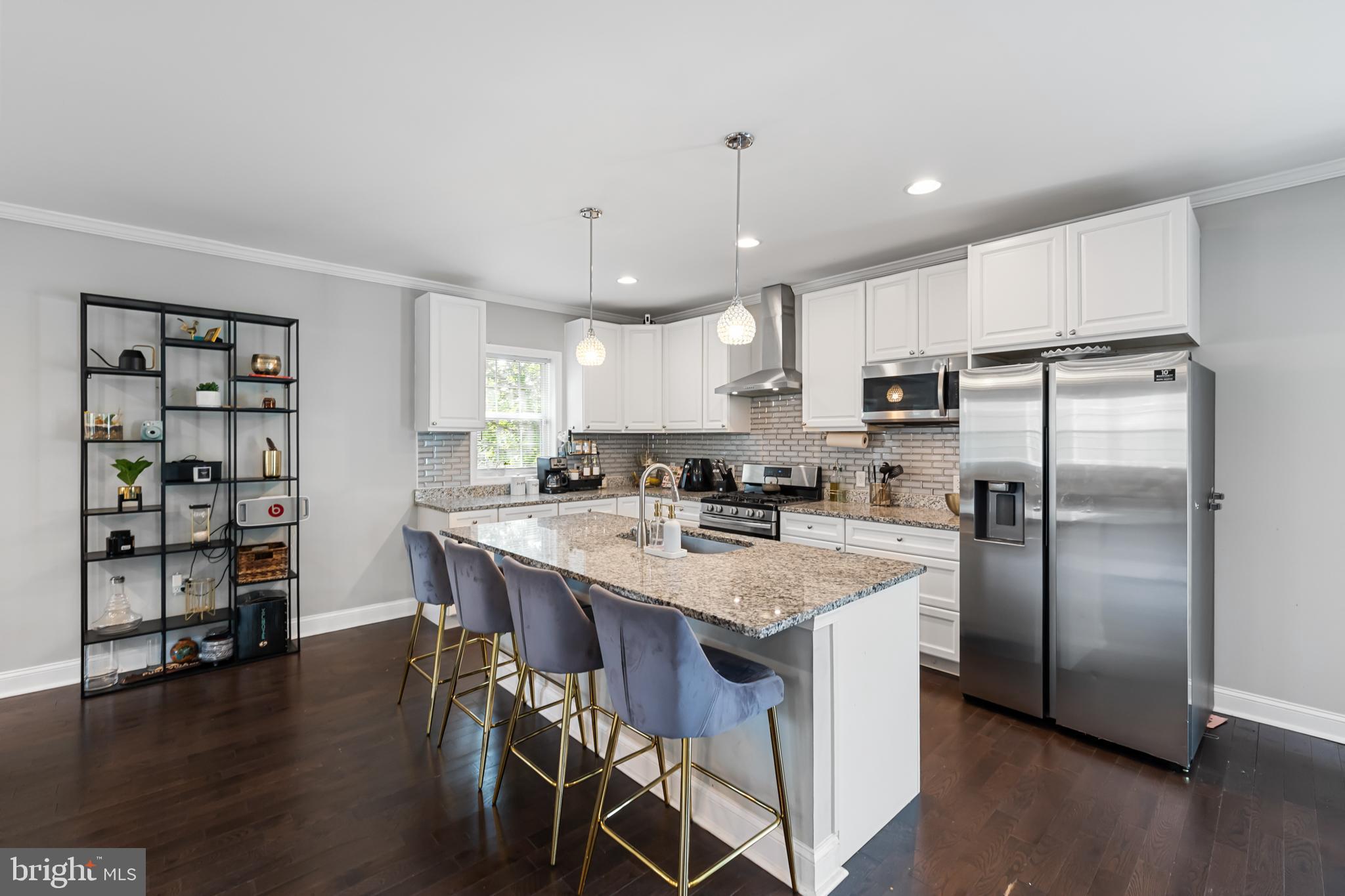 3327 5th Street Southeast Washington, DC 20032 - Photo 8 of 42 a kitchen with stainless steel appliances a dining table chairs refrigerator and microwave