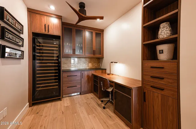 a kitchen with stainless steel appliances granite countertop a sink a stove a refrigerator and island with wooden floor