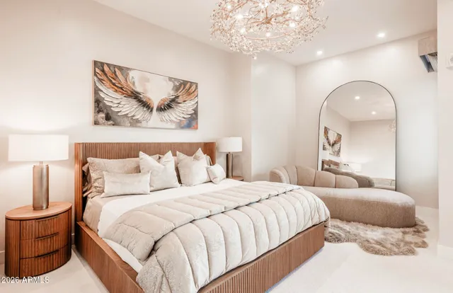 a bedroom with a bed and a painting on the wall