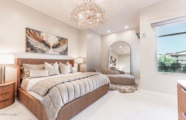 a bedroom with a bed and a painting on the wall