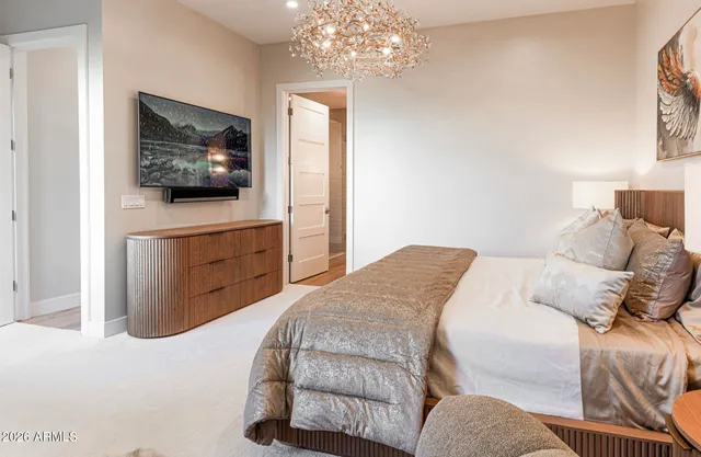 a bed room with a bed and a painting on the wall