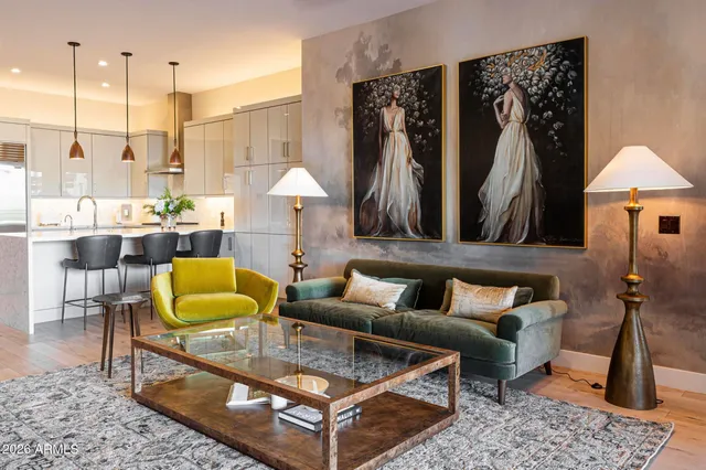 a living room with furniture a rug and a chandelier