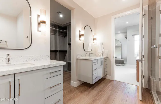 a en suite bathroom with a granite countertop sink mirror and shower