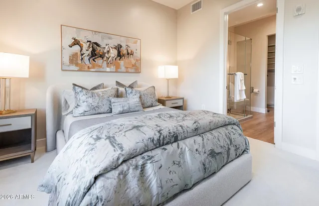 a bedroom with a bed and a mirror