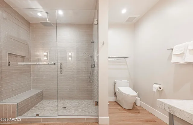 a living room with furniture a chandelier and a large mirror