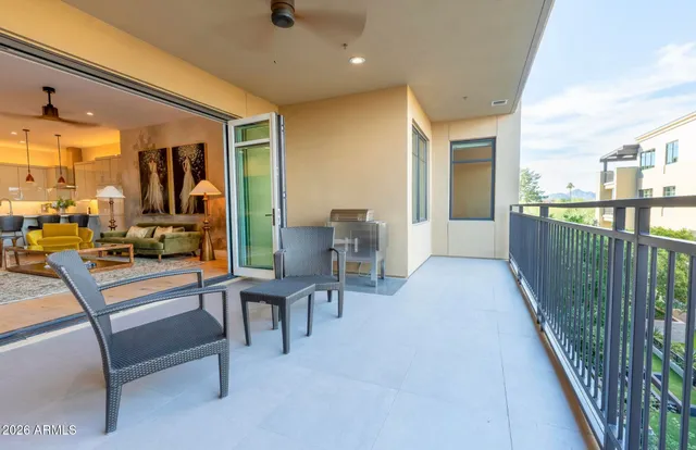 a dining room with lots of furniture and a view of kitchen